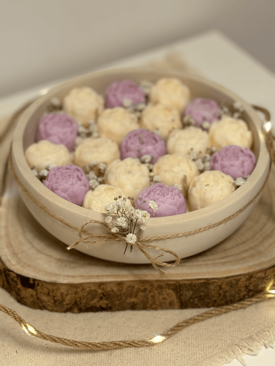 Large candle in a plaster container with peonies Large candle in a plaster container with peonies